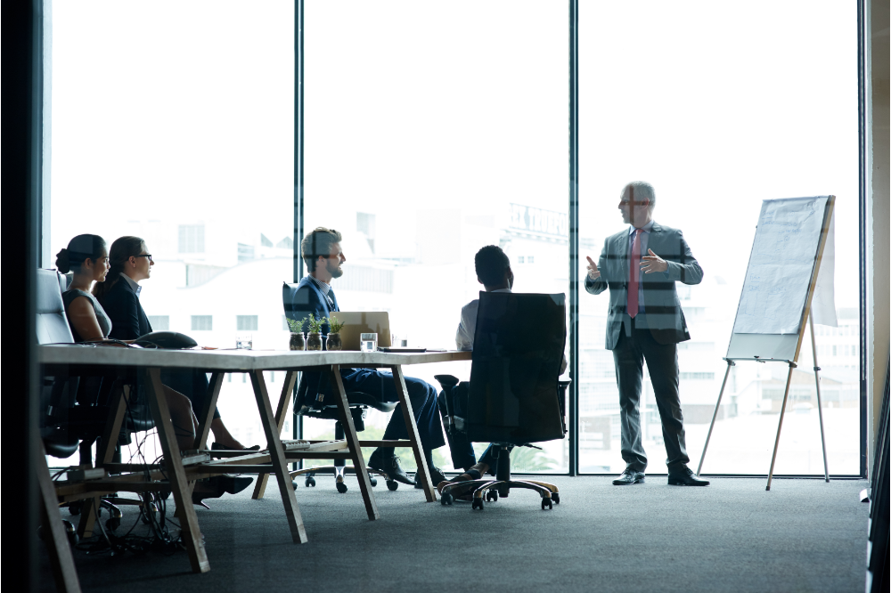 5 people in a boardroom implementing crm strategy